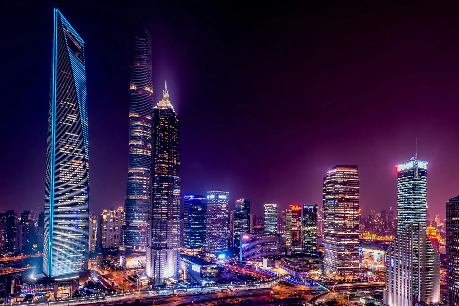 Majestic view of Shanghai's illuminated skyline featuring iconic skyscrapers at night.